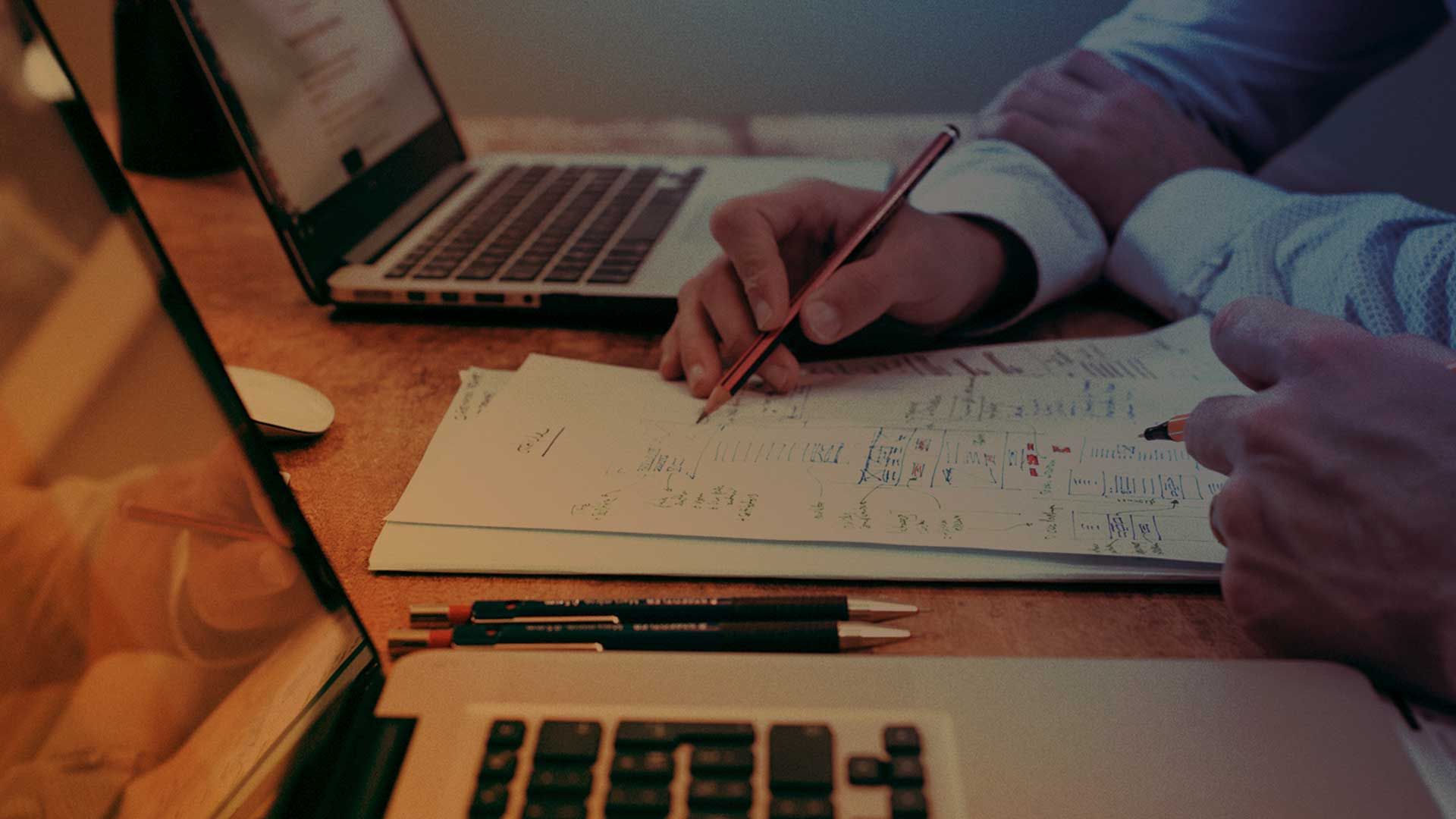 A man showing data services notes to a person next to him.